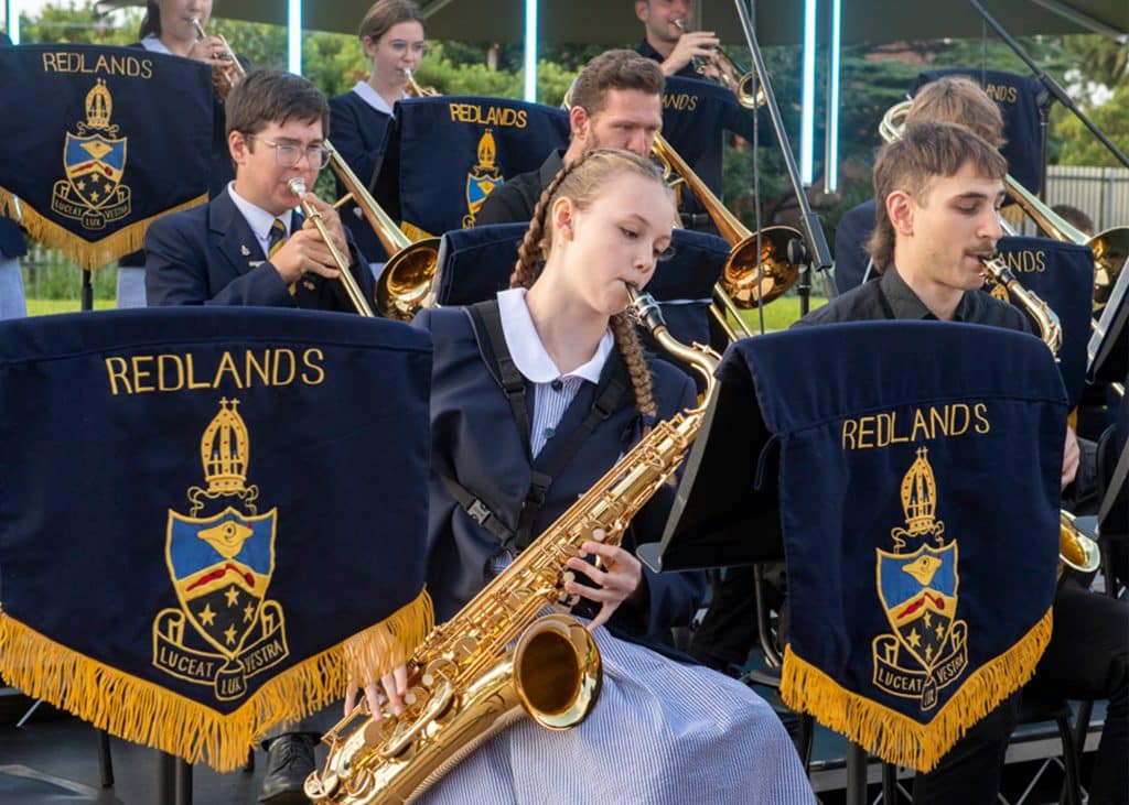 Redlands students playing a saxophone