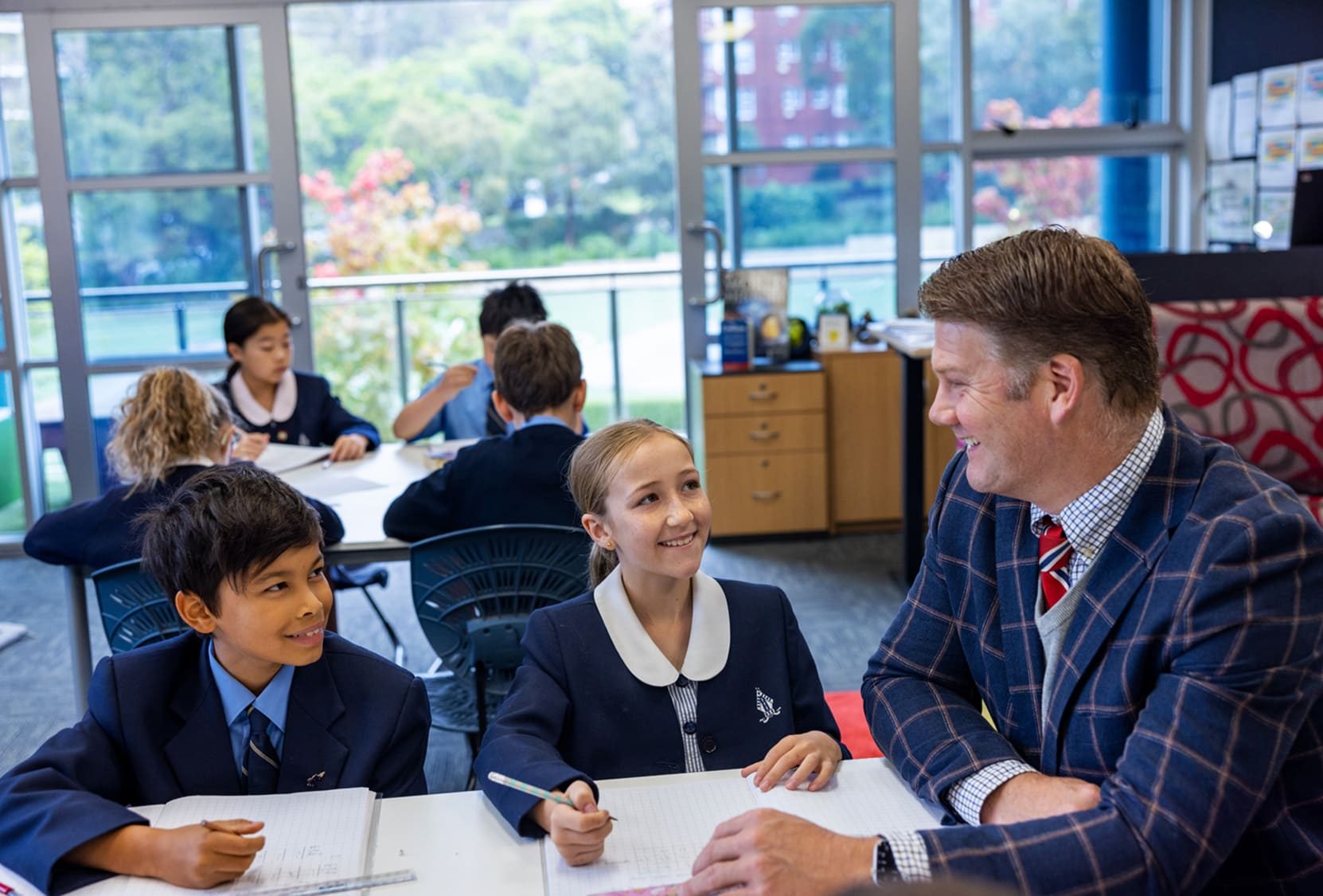 A Redlands teacher and two Junior School students in a classroom